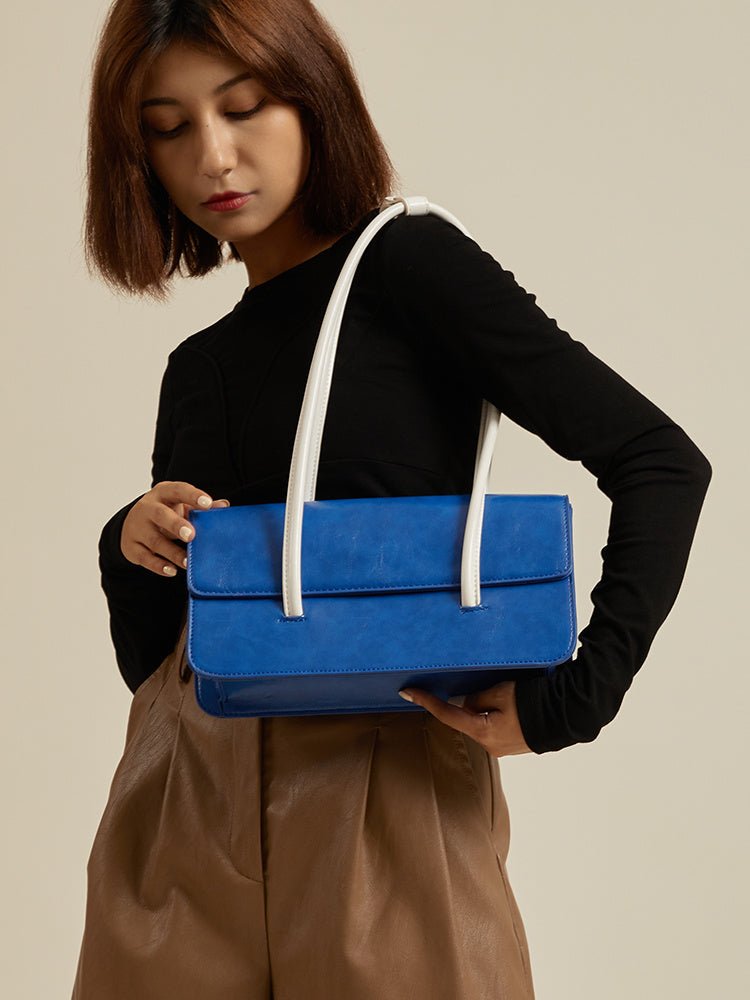 High Sense Of Klein Blue Contrast Color Handbag for Women, side angle view showing structured design and handbag handles